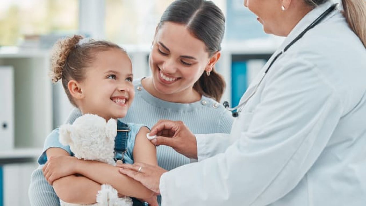 Shot of a doctor using a cotton ball on a little girl's arm while administering an injection in a clinic