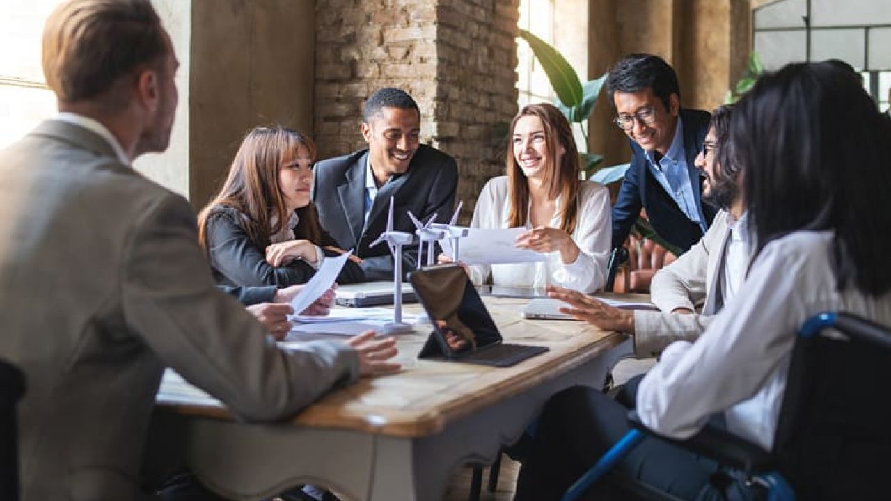Group of multiethnic businesspeople discussing about financial strategy, renewable power, sustainable innovation project and environmental economical issues - business, sustainability interracial lifestyle concept