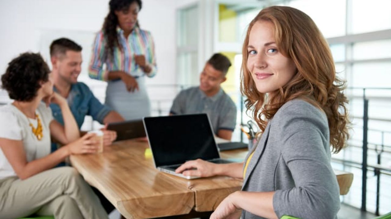 Image of a succesful casual business woman using laptop during